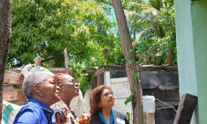 CCRP execs inspecting the roof that was repaired from funds donated for outreach